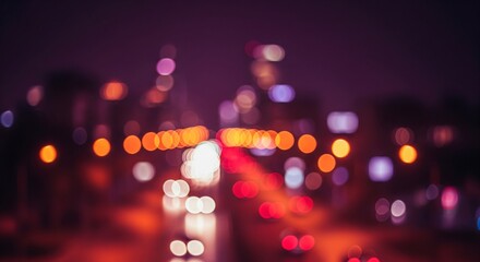An abstract, out-of-focus shot of colorful city traffic lights creating a beautiful bokeh effect at night.