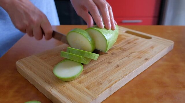 man cutting cucumber