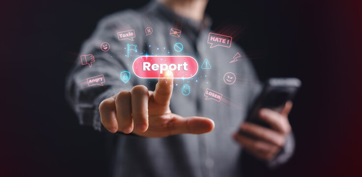 A person presses a glowing report button to stop toxic online messages, emphasizing cyberbullying prevention, digital safety, online protection, and awareness against harmful social media behavior.