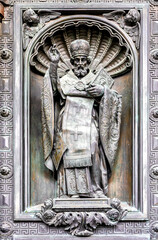 Detail of St. Isaac's Cathedral massive bronze gate featuring detailed sculptural reliefs of religious scenes