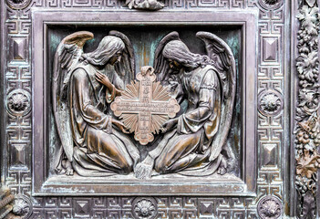 Detail of St. Isaac's Cathedral massive bronze gate featuring detailed sculptural reliefs of religious scenes