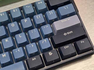 A high-angle close-up view of a modern mechanical keyboard featuring a compact layout.