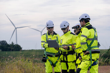 Wind energy team examines data and discusses project on a windy day at a renewable energy site