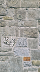 Vertical Stone Wall Background. Old Masonry Texture Pattern with Rectangular Gray Blocks and Individual Weathered Stones for Architectural Design.