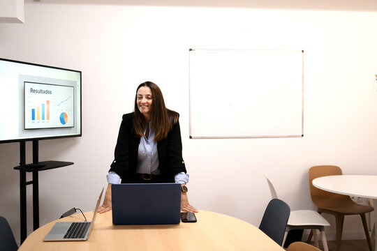Professional businesswoman presenting data results in office conference room