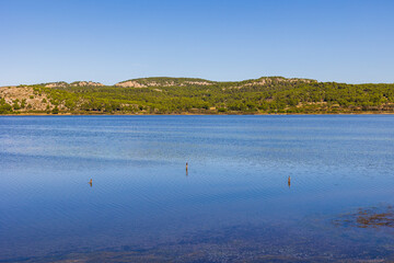 Village of Gruissan on the horizon from the opposite shore of the Gruissan lagoon