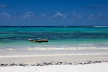 Beautiful white sand beach. Beach in Zanzibar. Sunny day. Blue sky. Colorful sea.