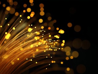 Glowing golden fiber optic strands with warm light tips and soft bokeh circles against a dark abstract background.
