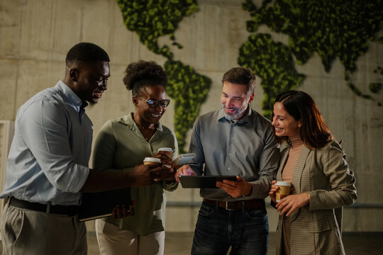 Diverse business people brainstorming with tablet on coffee break