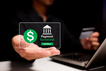 A person holding a transparent screen showing a successful payment notification while interacting with a laptop.