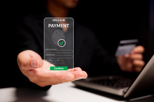 A futuristic digital payment interface is displayed, featuring a fingerprint verification and a credit card, set against a dark background. - Powered by Adobe