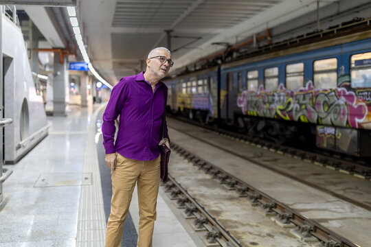 Senior man waiting for subway train at station