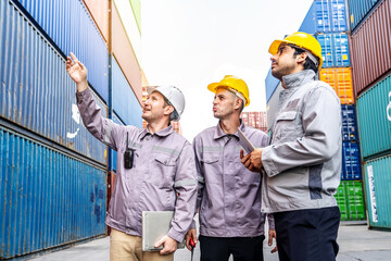In container terminal, Team of industrial engineers in safety vest uniform and helmet works together on a laptop, ensuring efficient logistics and safety in cargo shipping operations, Teamwork