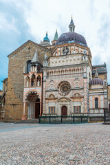Facade of the ornate Colleoni Chapel in Bergamo old town, Citta Alta, Lombardy, Italy. Italian cobblestone city square with Renaissance and Lombard architecture. Vertical orientation