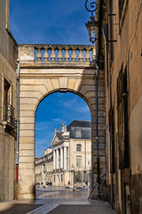 View through a city gate onto Liberation Square and the Palace of the Dukes of Burgundy (Palais des ducs de Bourgogne) in Dijon, Burgundy, France