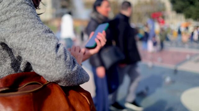 Traveler woman navigating barcelona with smartphone, enjoying urban exploration and cultural tourism at famous architectural landmark casa batll&oacute; on passeig de gr&agrave;cia