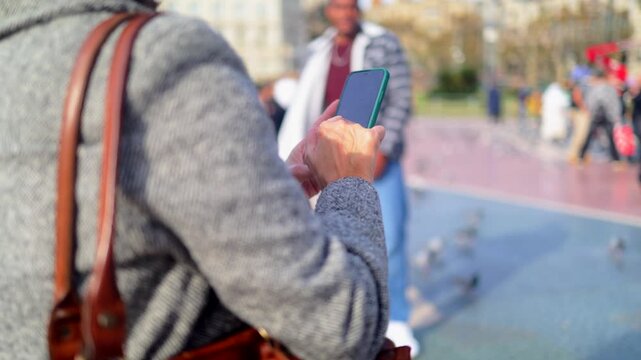 Traveler woman navigating barcelona with smartphone, enjoying urban exploration and cultural tourism at famous architectural landmark casa batll&oacute; on passeig de gr&agrave;cia