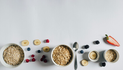 Delicious healthy breakfast with oatmeals, bananas, blueberries and raspberries energizes you for a great day, promoting well being and vitality