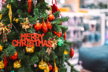 A festive Christmas tree decorated with colorful ornaments, shiny baubles, gift boxes, and holiday ribbons, creating a warm seasonal atmosphere perfect for celebration themes and winter holiday design