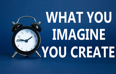 What you Imagine you Create you symbol. Wooden blocks with words What you Imagine you Create. Beautiful deep blue background with alarm clock. What you Imagine you Create concept. Copy space.