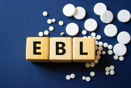 EBL symbol. Wooden cubes with words EBL estimated blood loss. Beautiful deep blue background. Healthcare and estimated blood loss concept. Copy space.