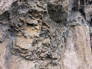 Rugged Cliff Face With Jagged Granite Rocks In A Natural Quarry Scene