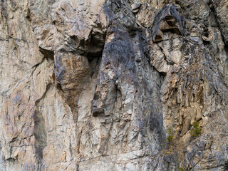 Rugged Cliff Face With Jagged Granite Rocks In A Natural Quarry Scene