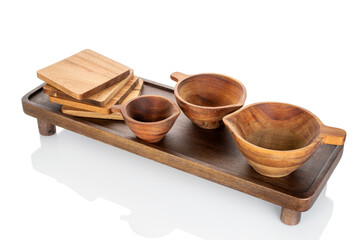 Wooden kitchen table with wooden cups isolated on white background, close-up.