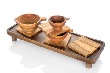 Wooden kitchen table with wooden cups isolated on white background, close-up.