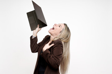 Woman screaming frustration at broken laptop technology