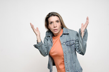 Woman shrugging with hands up expressing confusion reaction