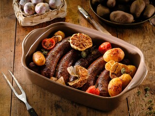 Succulent pork sausages are roasted alongside golden potato wedges and whole garlic cloves, infused with fresh herbs. This dish embodies rustic Romanian comfort for a delicious winter meal
