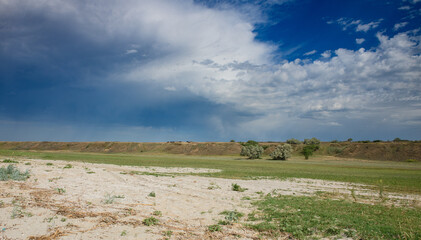 Obraz premium Wide steppe landscape of Kherson region, Ukraine with a low horizontal embankment on the horizon