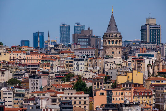 Panoramic view of the historic Galata district, showcasing the iconic Galata Tower rising above a dense pattern of traditional Istanbul houses, Turkey