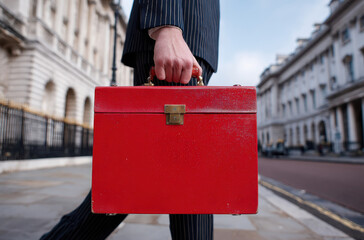 Fototapeta na wymiar Red UK Budget Briefcase Held by Businessperson