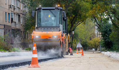 Road roller laying asphalt on a city street