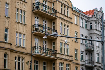 Obraz premium Historic apartment building with balconies and ornate facade in European city street architecture nineteenth-century residential urban