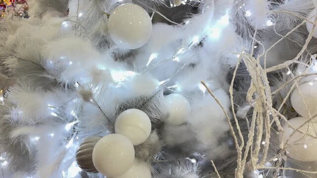 4k footage close up of lighted Christmas tree ornaments and decorations. Mistletoe, baubles, and bell with Interactive sparkling christmas twinkle lights or icicle lights.