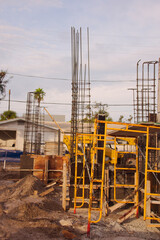 Active Construction Site With Signage, Rebar, and Wooden Forms in Early Stage Building. In St. Pete Beach, FL. Daylight highlights ongoing development, urban growth, and the sense of industry and prog