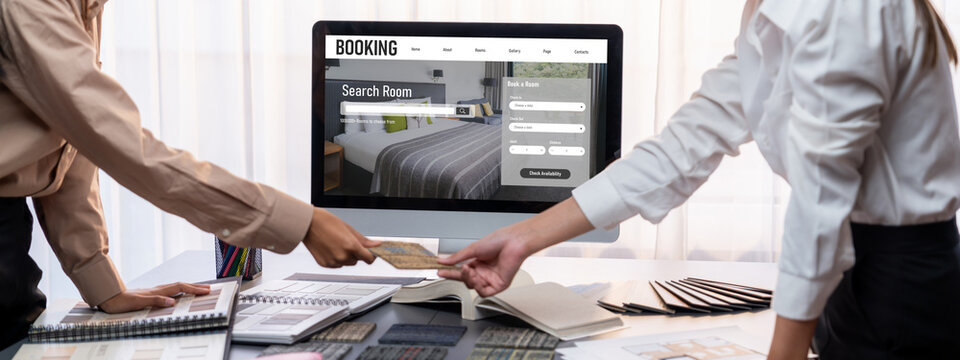 Group of interior architect designer team at table choosing various mood board samples with architecture software on laptop screen. Modern renovation and interior material selection concept. Insight