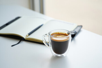 Coffee Cup and Journal on White Surface Offering Moment of Reflection Productivity and Planning for Creative Work or Personal Use
