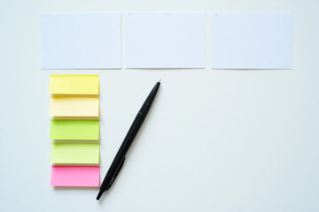 Blank White Cards with Colorful Sticky Notes and Black Pen on White Surface for Office Supply and Planning Concept 150 Characters