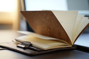 Leather Journal Open on Office Desk for Note Taking Agenda Planning and Organization with Pages Turned and Light Background 150
