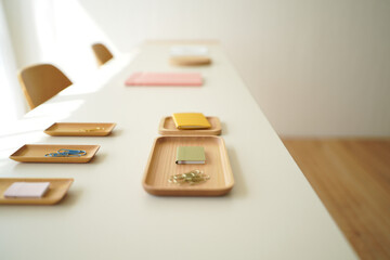 Small Wooden Trays with Stationery Items on White Table Minimalist Office Supplies Arrangement Minimalist Office Workspace 150 Characters