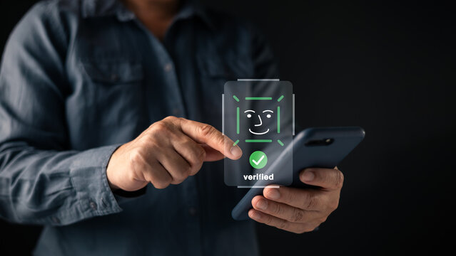 Facial recognition verification concept show hand hold a smartphone with a digital face scan icon, secure identity authentication, biometric technology, privacy protection, and modern mobile security.