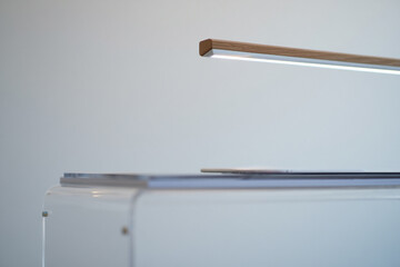 Minimalist Desk Lamp on White Table Providing Bright Illumination for Modern Workspace and Task Lighting with Soft Ambient Light