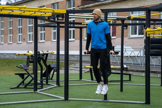 Man performing dips on an outdoor calisthenics rig