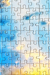 Jigsaw puzzle pieces.Colorful background with small puzzle pieces, messy.Some colored pieces of puzzle as background.Challenge and solution concept. Hobbies and leisure activities