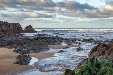 Cornish South West rock and sandy coast at dawn in winter