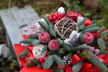 Christmas Floral Arrangement with Fir Branches, Red Ribbons and Holiday Decorations